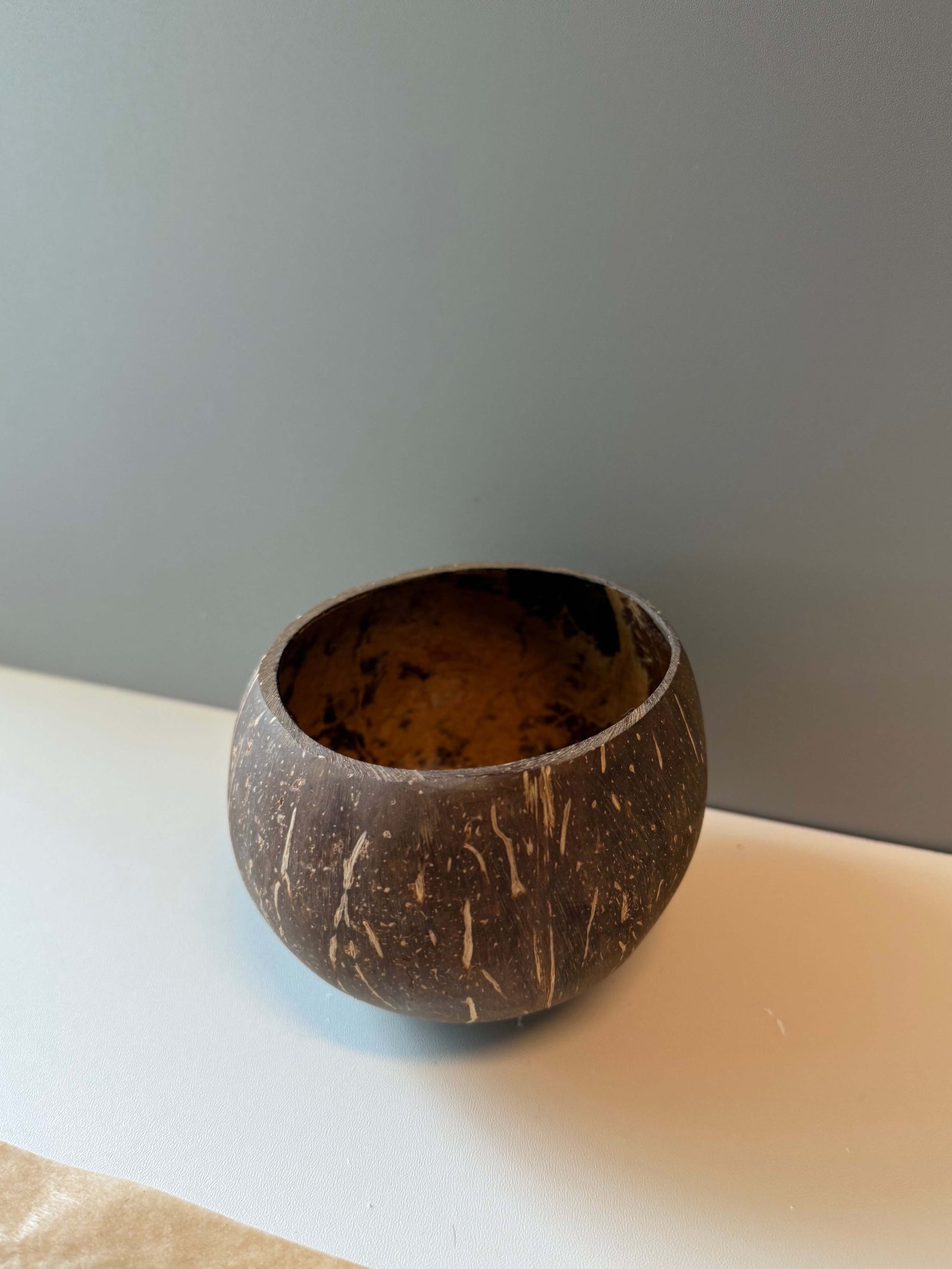 Handcrafted natural coconut shell bowl, perfect for candle making or rustic home decor.