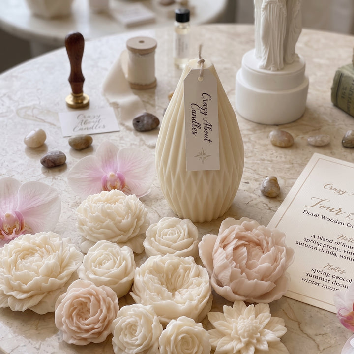 A cream-colored textured candle with a hanging tag reading &