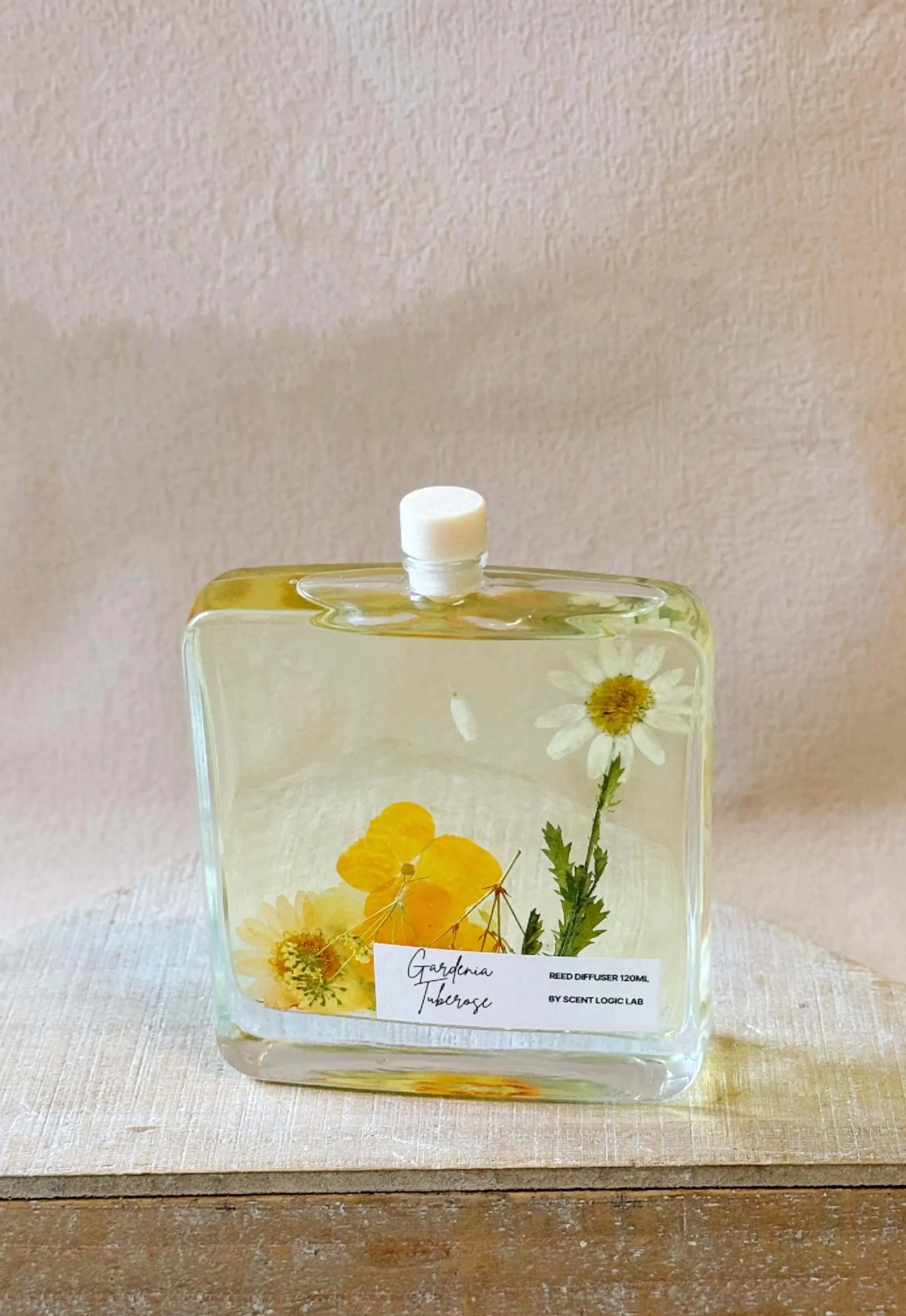 Handcrafted botanical reed diffuser in glass bottle with dried flowers, perfect for home decor and unique gift ideas.