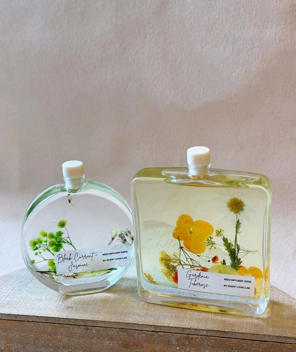 Handcrafted botanical reed diffusers with real dried flowers in elegant glass bottles, perfect for home decor and gifts.