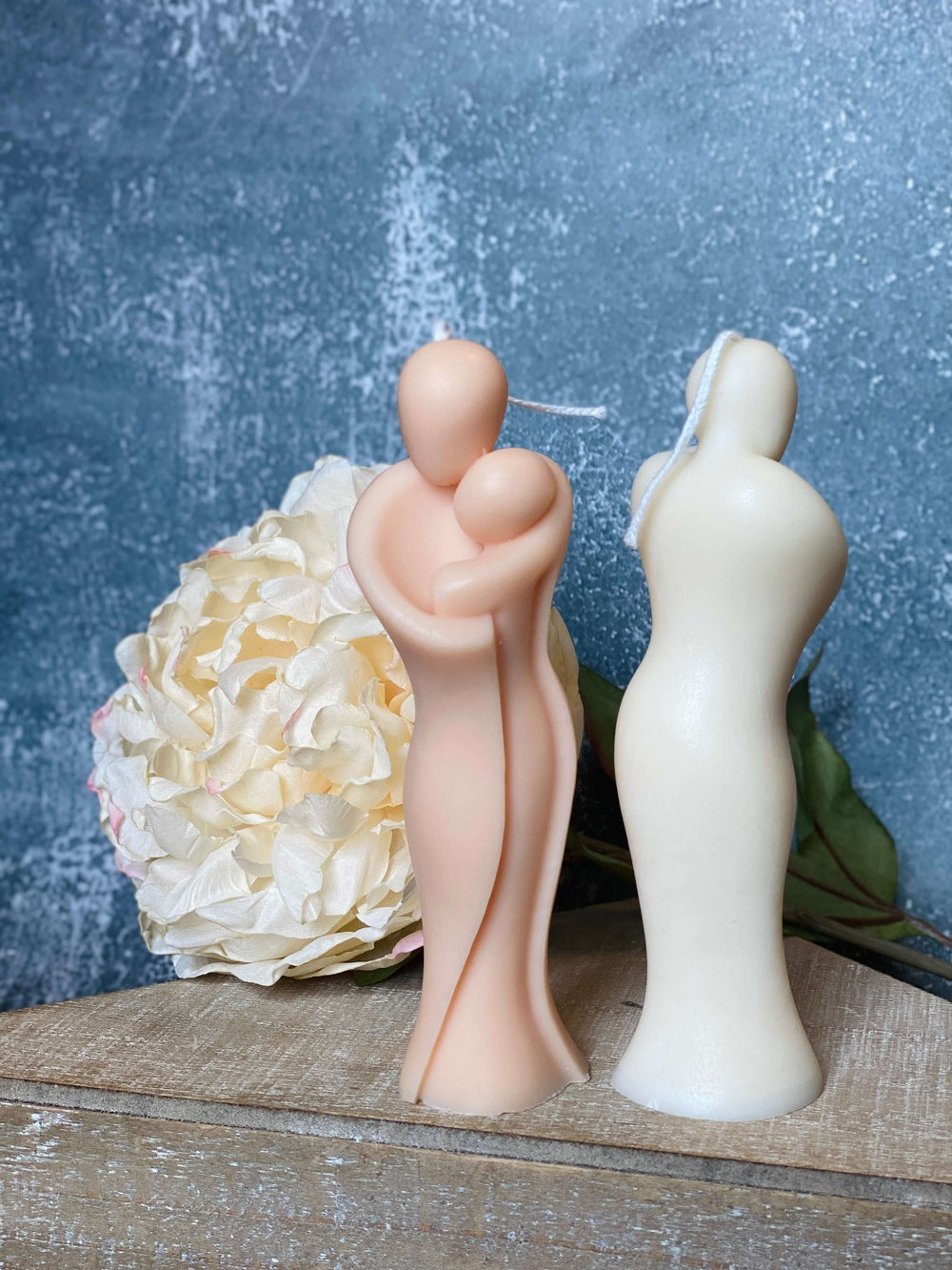 Handcrafted candle of mother hugging child