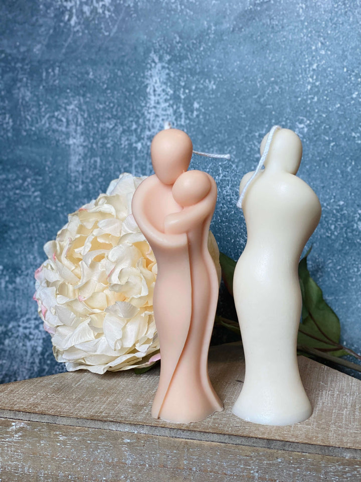 Handcrafted candle of mother hugging child