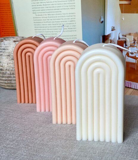Colorful rainbow-shaped soy wax candle